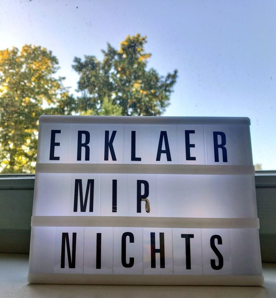 Beleuchtete Tafel mit Buchstaben 
ERKLAER 
MIR 
NICHTS