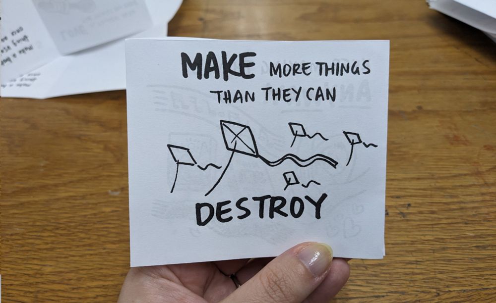 Zine, final page, reading "Make more things than they can destroy."  Image of kites flying in the air.