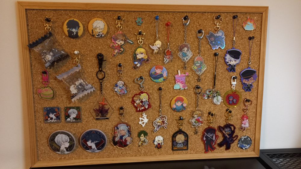 pinboard covered in charms, pins and buttons