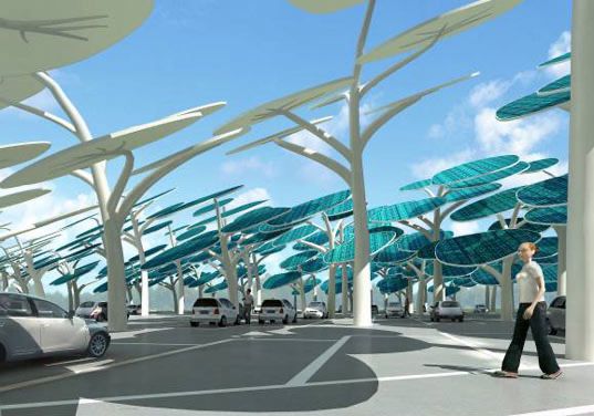 A parking lot where shade is provided by very large tree-like structures. The giant leaves of the trees are shaped like leaves. 