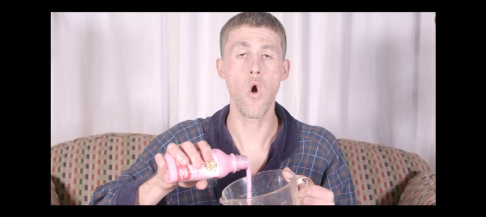 Sven Gamsky, aka Woozy of Still Woozy pouring Pepto into a blender in the video for Cooks (link to song in replies) 