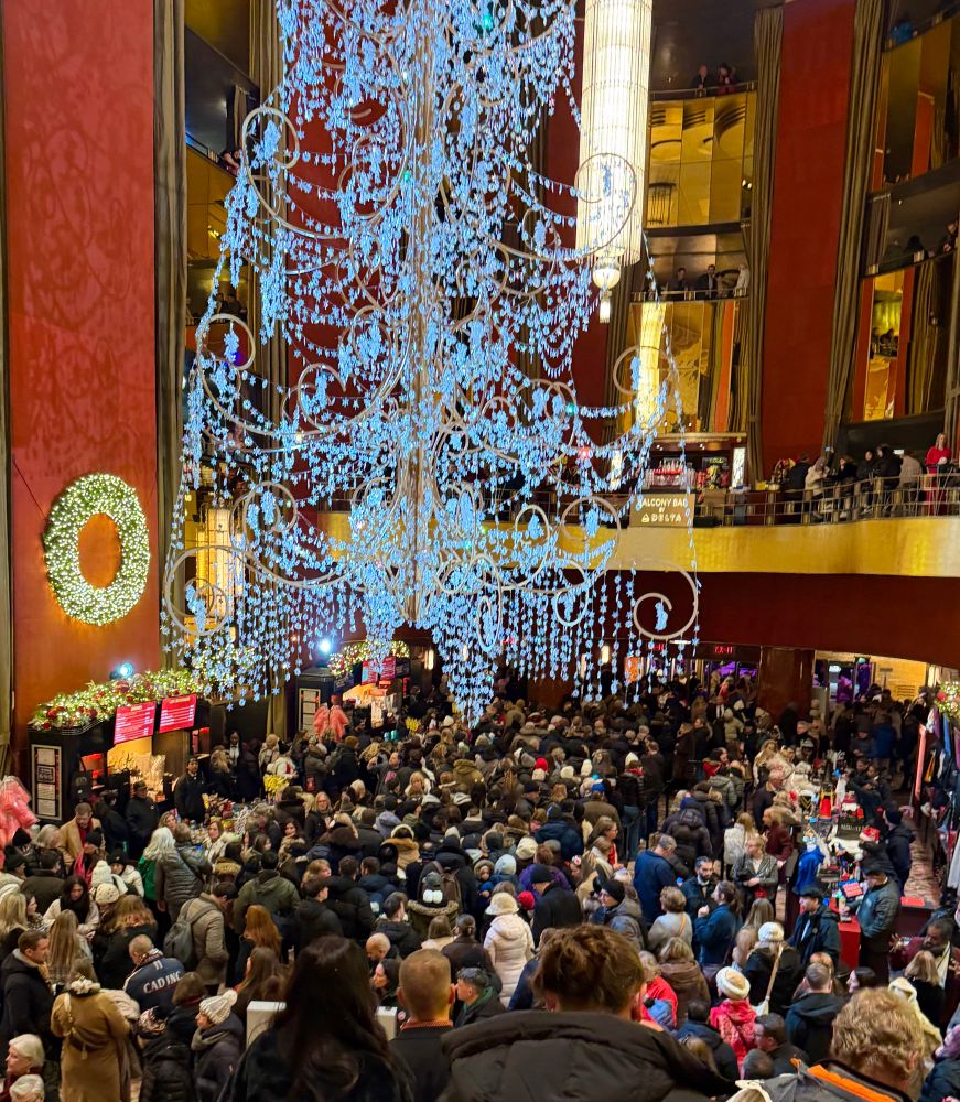 The lobby jam-packed wall to wall with festive humanity. 