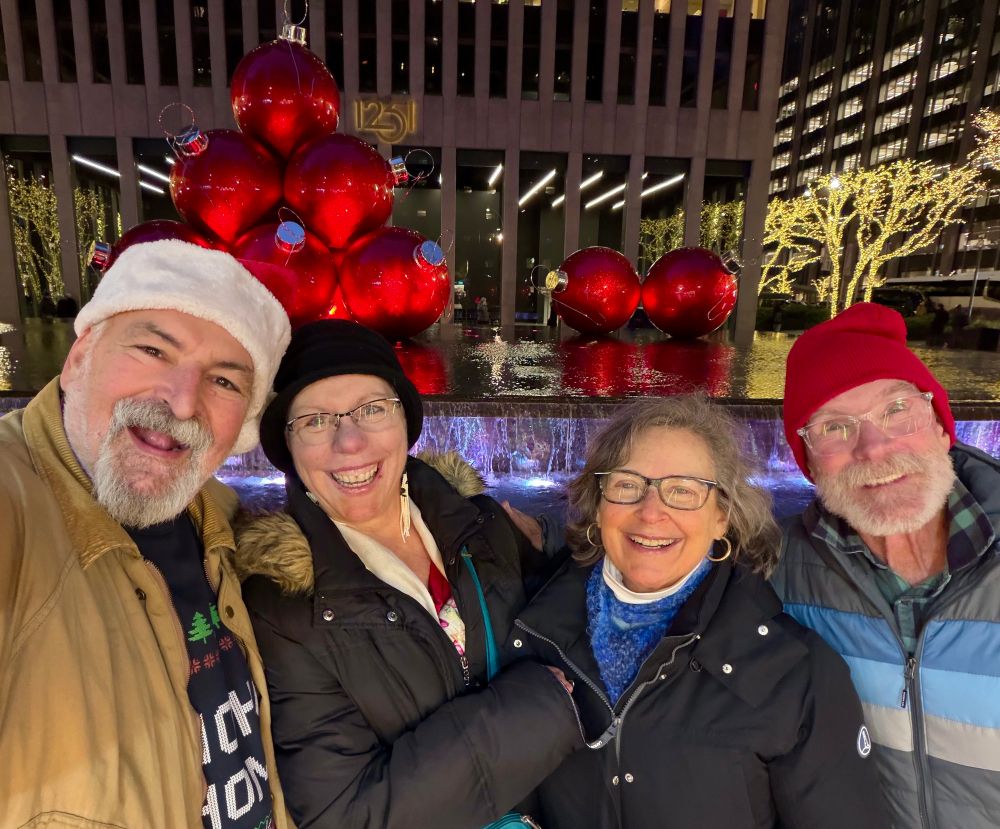 Self, Allison, Michelle, and Mike with giant balls (red Christmas ornaments in the fountain across from Radio City)