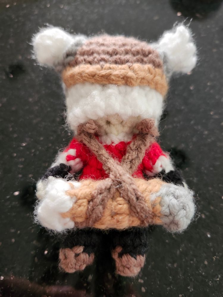 a photo of a crochet doll from behind