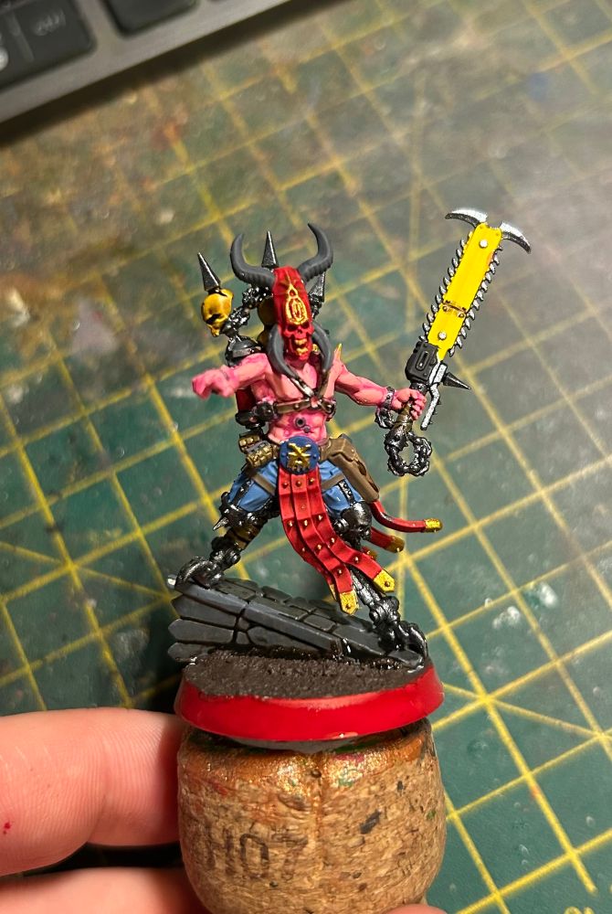 A nicely (if I do say so myself) painted warhammer model. This model is a goremonger, a devotee of the blood god Khorne who emulates a favourite demon.
