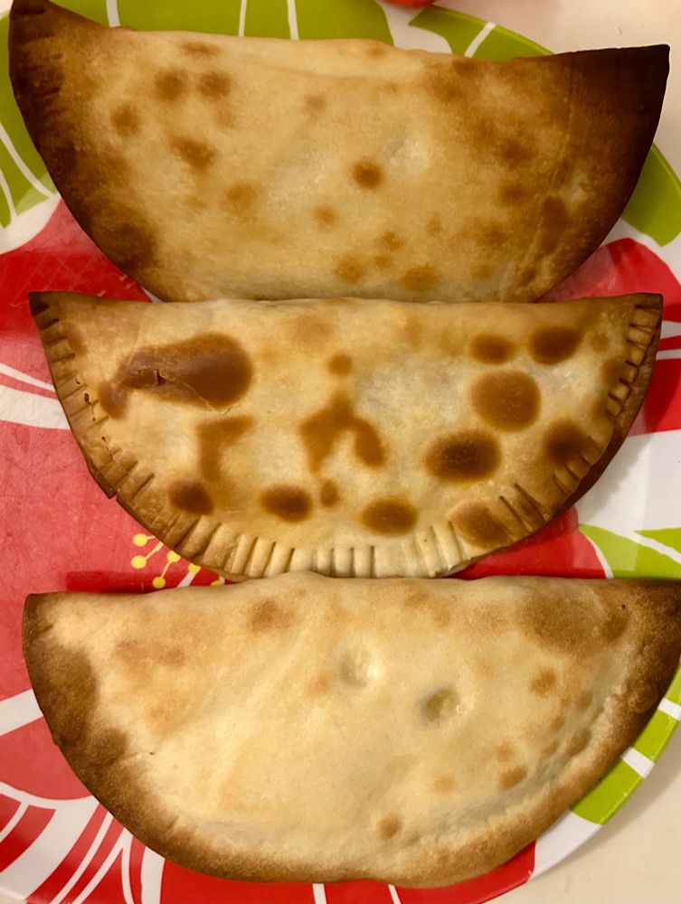 Calzones or empanadas on plate stuffed with Thanksgiving food