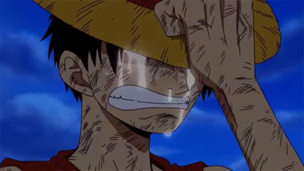 a man in a straw hat is crying with a tear coming out of his eyes