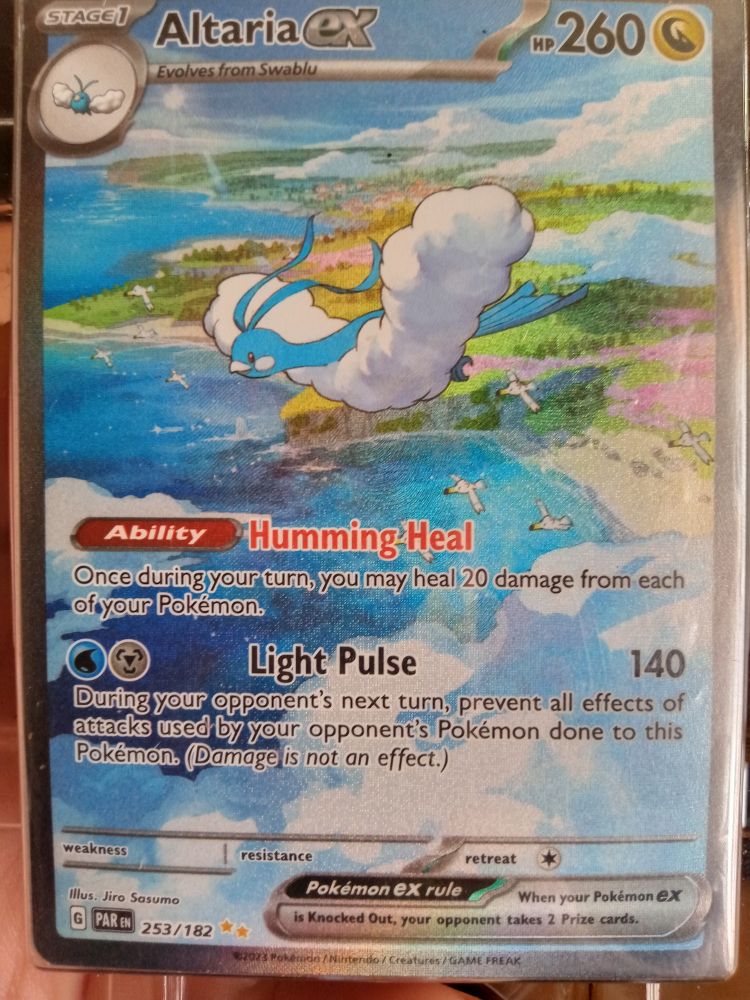 A pokemon card. It's an Altaria EX secret rare full art. Online estimated prices were between 30 and 60 dollars.