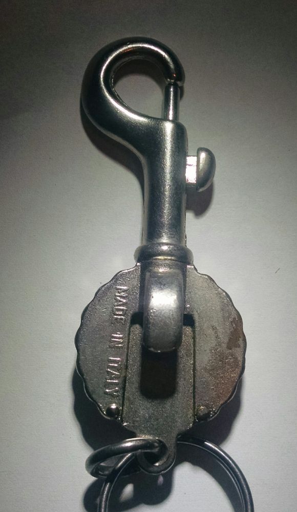 Back side of a bottle-opener key chain. On the back side you can see the bottle opener feature, and that it is stamped "MADE IN ITALY"