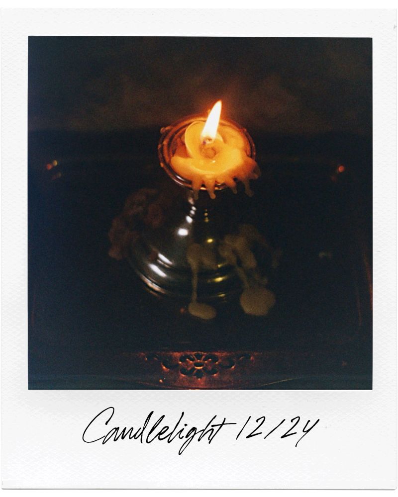 A candle burning in the darkness