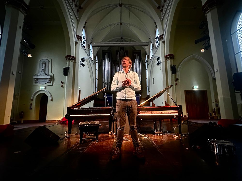 The performance features two traditional grand pianos: one played directly by the artist, the other equipped with a self-playing mechanism triggered by MIDI data. The MIDI data can be generated and varied in real-time via additional keyboards, controllers, and AI agents. The sound of the self-playing piano can be modulated in real-time through preparations of the piano. Extracted MIDI data can also be used to trigger a variety of virtual pianos and piano samples.