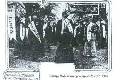 A photograph published in the Chicago Daily Tribune, black and white, showing Ida B. Wells in regalia marching with suffrage activists 