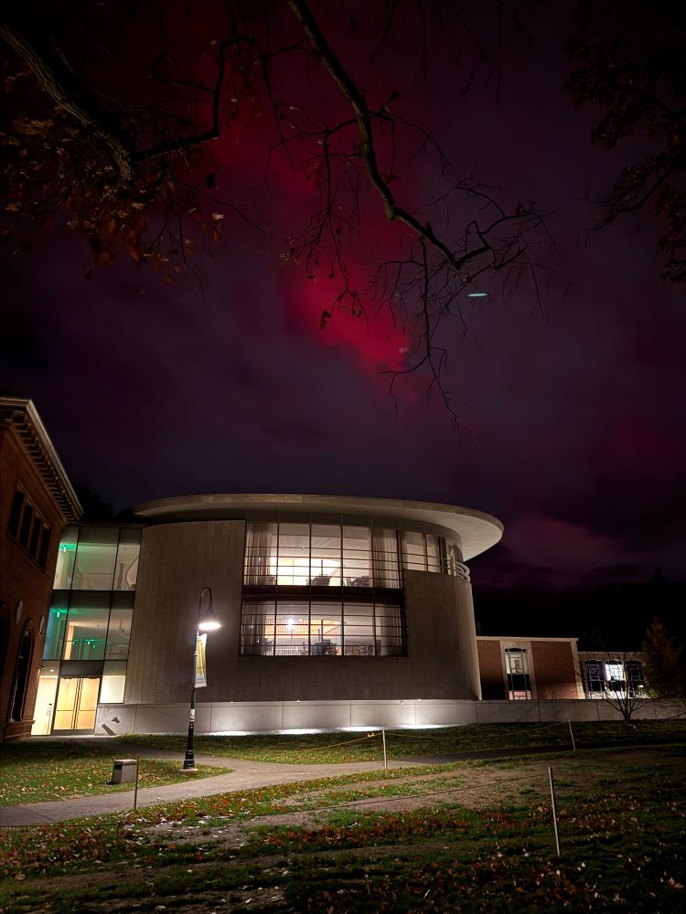 Vivid red lights above the library. Purple clouds..