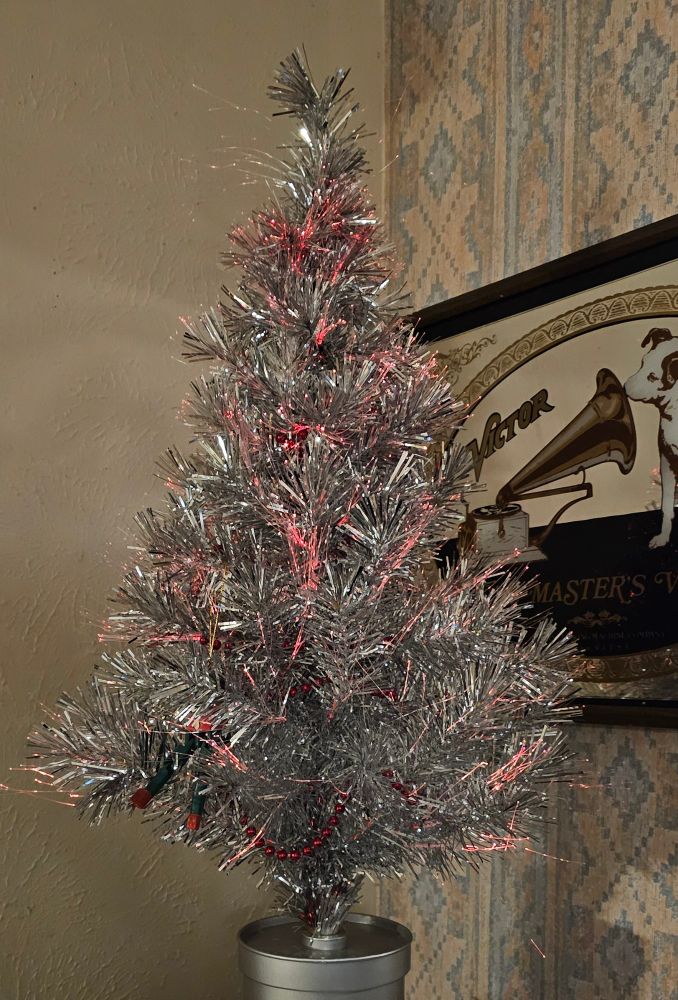 An inexpensive tabletop tinsel tree gutted of its lights and replaced with am ESP-32, a Neopixel ring, and software to make the tree show the current Cheerlights color.