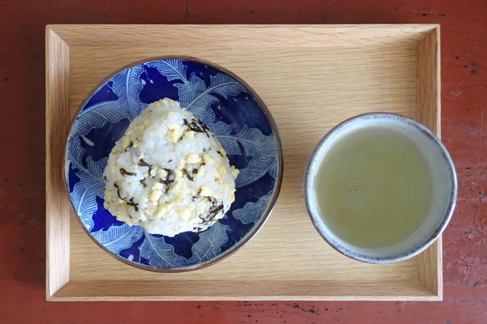 いりたまご・刻みのり・いりごまを混ぜ込んだ飯のおむすび、薄い阿波晩茶