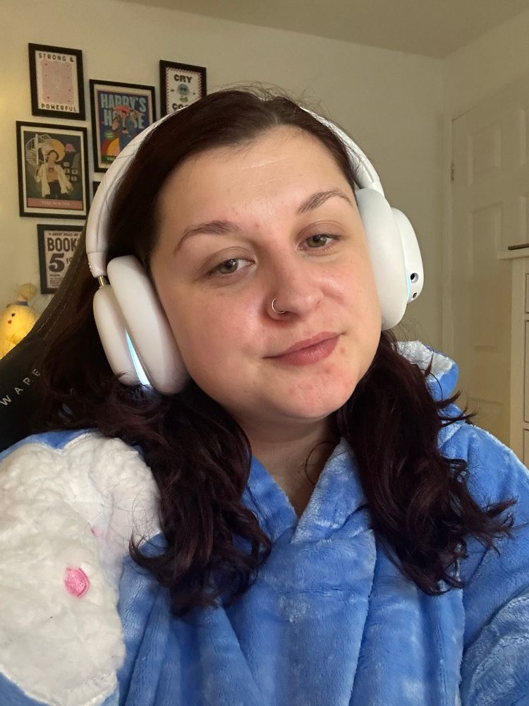 a selfie of Kira wearing her white over ear Logitech headset and her BRAND NEW (ad gifted) oodie! The oodie is light blue with white fluffy cartoon clouds on it) 