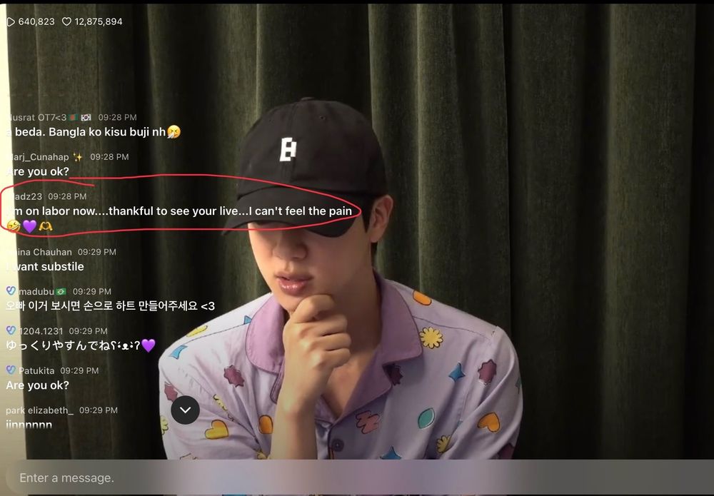 Screenshot of a weverse live of Jin of BTS, he's wearing his pijamas and a black bighit hat, there's a highlighted text that says I'm on labor right now...thankful to see your live...I can't feel the pain