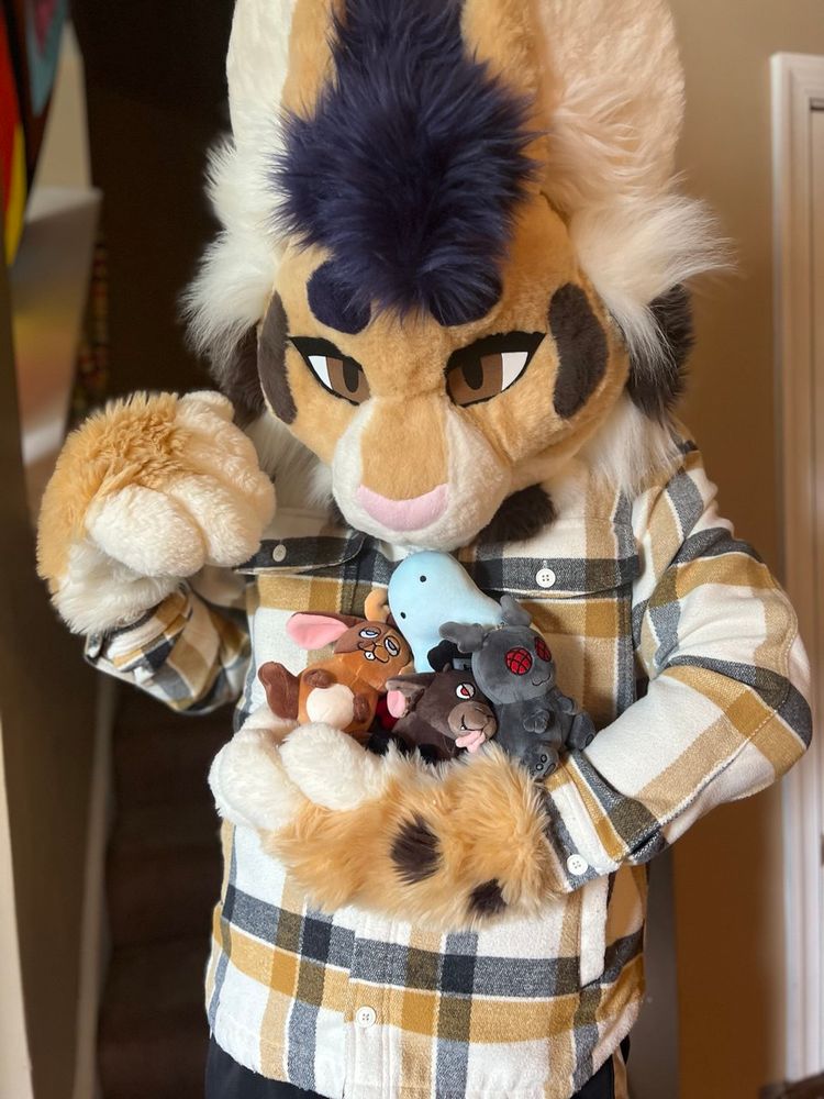 Lynx Forster holding too many cryptid plushes made by Saba 