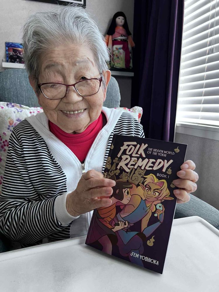 My grandmother Taeko holding a copy of Folk Remedy book 1