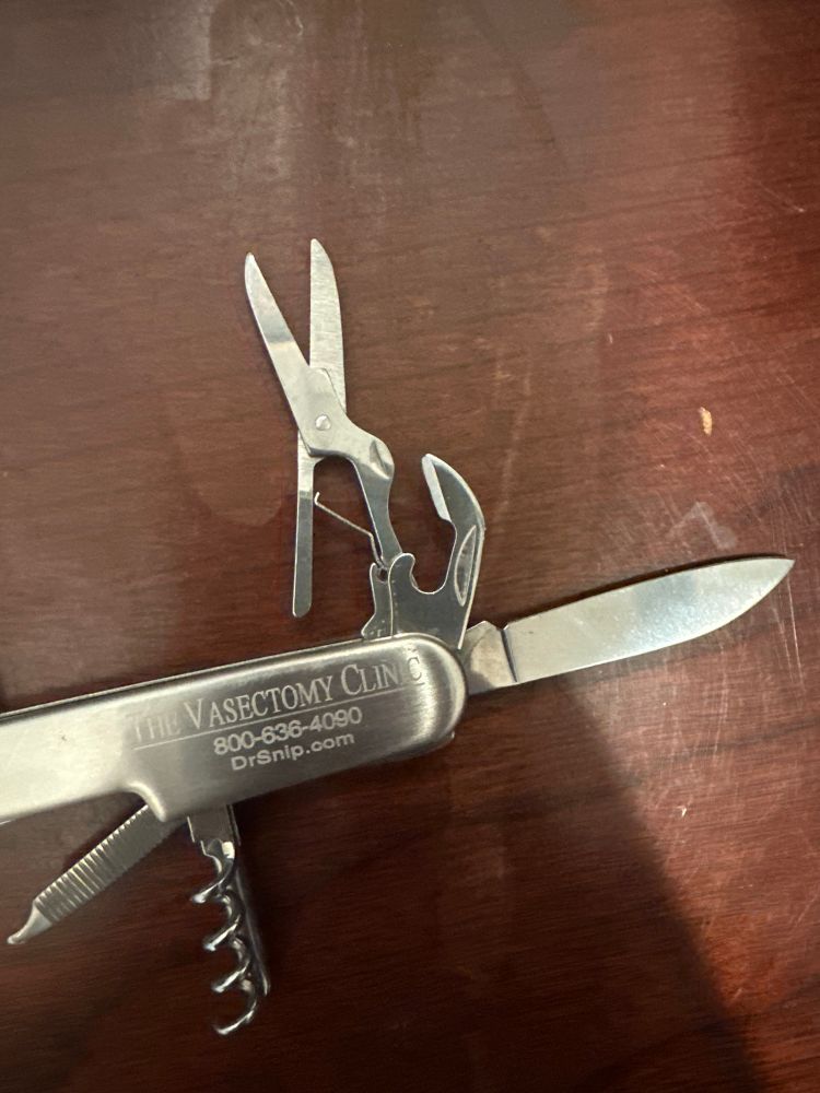A multitool knife with vasectomy clinic information engraved on it. 