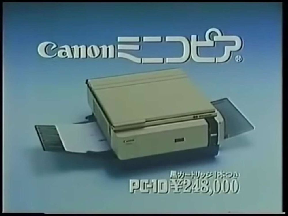 Screenshot from a 1982 TV commercial, it shows a small photocopier, and says Canon PC-10 248,000 yen and a small amount of Japanese text.