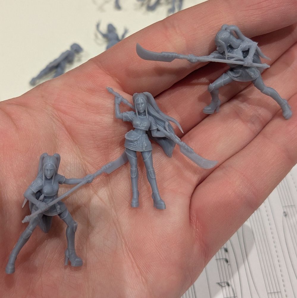 Picture of three unpainted minis of Mira from KPop Demon Hunters.