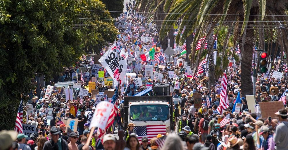 Image showing MASSVIE crowd of No Kings protesters as far as the eye can see, taking up a whole street and maybe like 100,000 people even. 