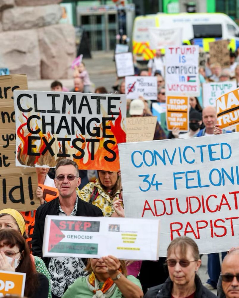 Photo of crowd of Scottish protesters, with signs that say CLIMATE CHANGE EXISTS, STOP THE GENOCIDE, TrUMP IS A CONVICTED 
34 FELON ADJUDICATED RAPIST”
