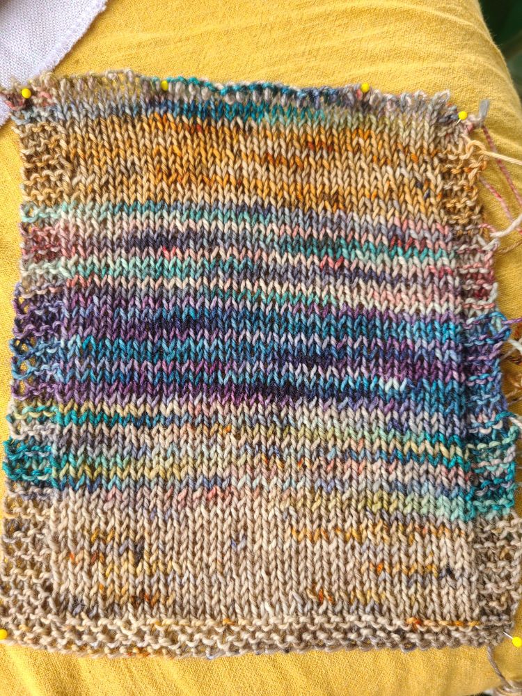 A knitted swatch of ten rows each of the five different colourways from my previous post.