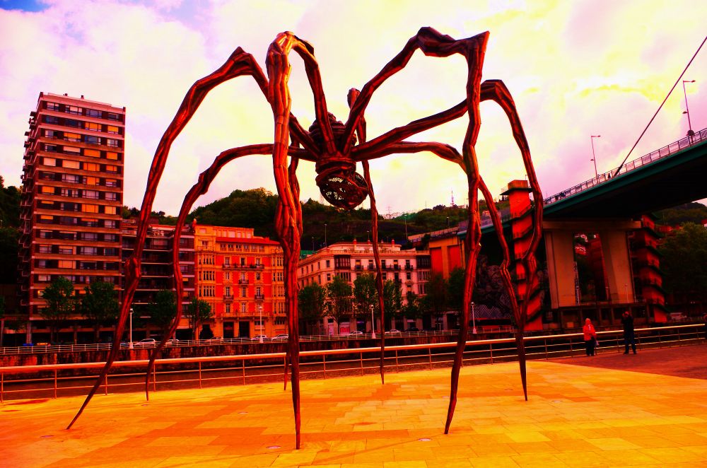 giant, spindly rustred metal spider. a cheery fellow