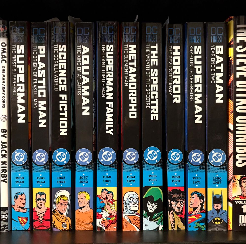 Ten different volumes of DC Finest collections on a shelf.