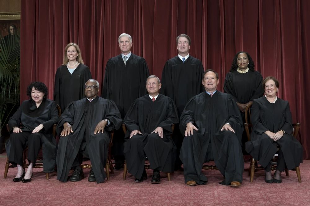 A photo of the us supreme Court with a picture of a slavery sympathizer in the background