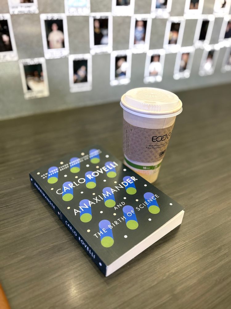 The book Anaximander and the Birth of Science by Carlo Rovelli next to a to-go coffee