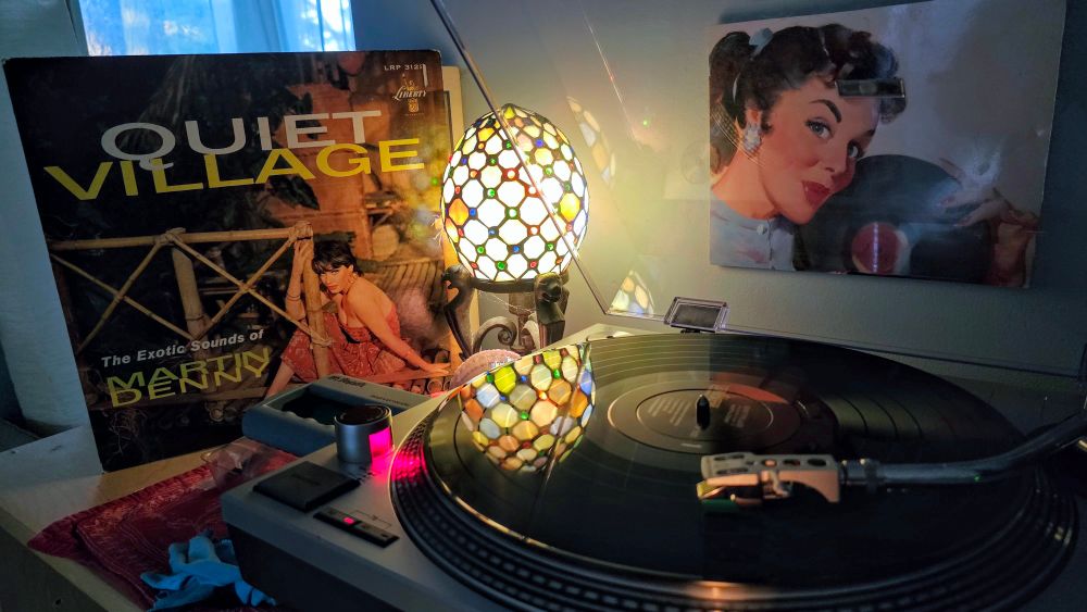 A turntable playing Martin Denny's "Quiet Village" LP