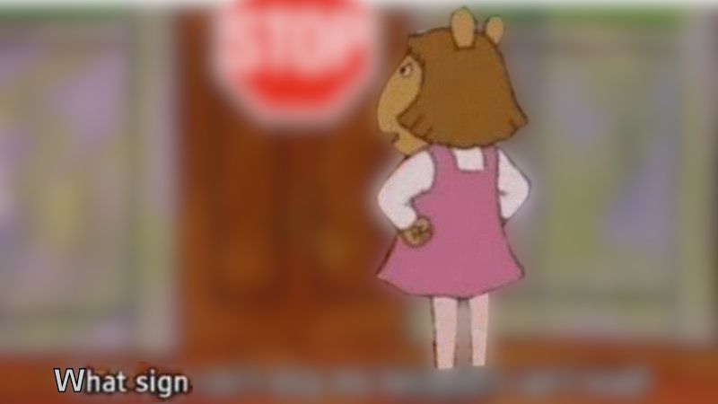D.W. from the cartoon arthur standing with her fists on her hips, looking indignant in front of a blurry background and sign. The caption reads: "What sign"

The sign reads: "STOP"