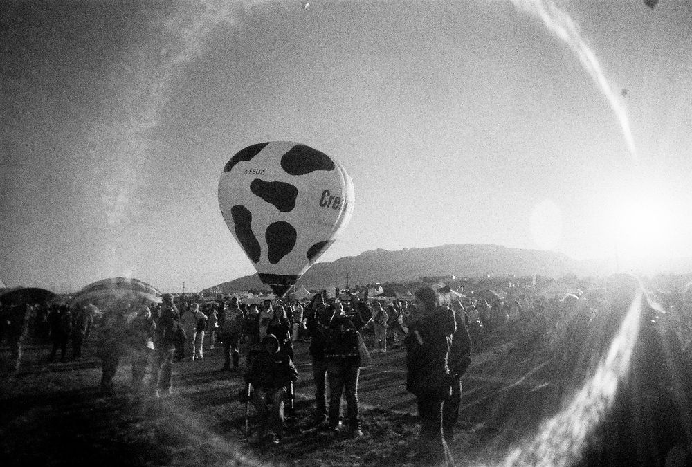 Black and white photo of the creamland dairy hot air balloon surrounded by a circular lens flare 