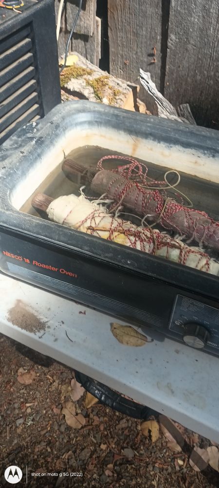 A roasting pan with two bundles inside 