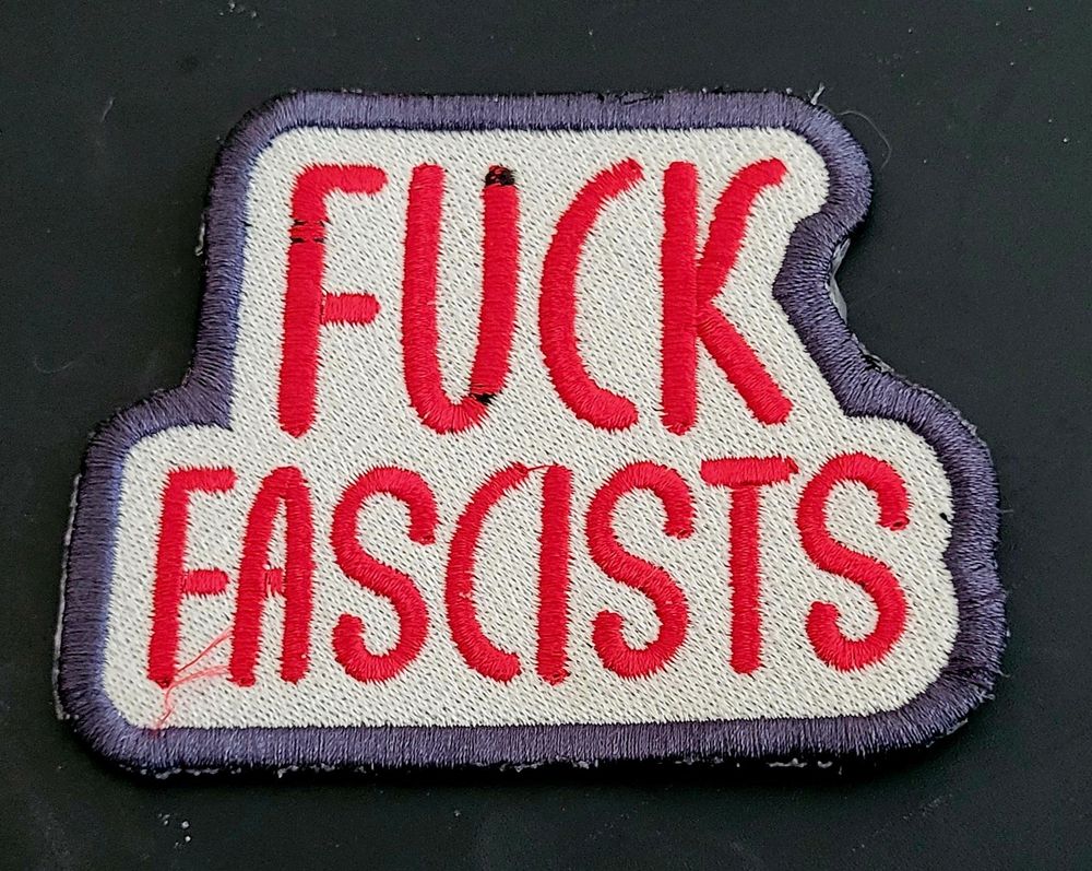 A patch that reads "fuck. fascists"
