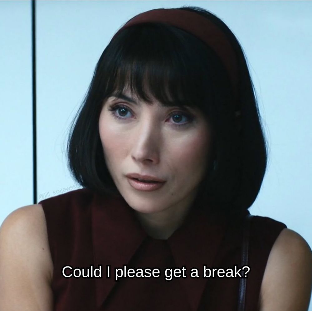 Gemma from severance, a Tibetan-Australian woman, with a bob haircut and a crimson sleeveless top with a collar. The line in white says "could I please get a break?"