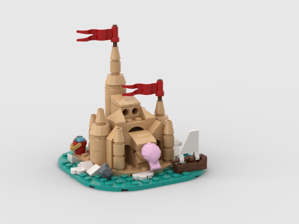 Front of small Lego sandcastle with 2 flags, a small boat, a little bucket and a shell on the front of the castle. The castle has towers, windows and arches.