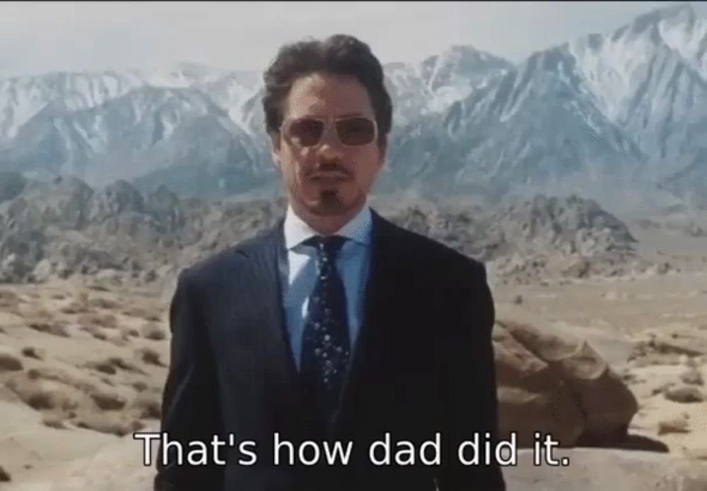 a man in a suit says that 's how dad did it in front of mountains