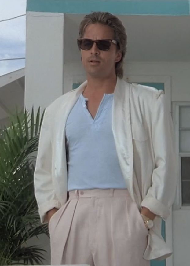 Crockett from Miami Vice in an off white blazer with the sleeves rolled up