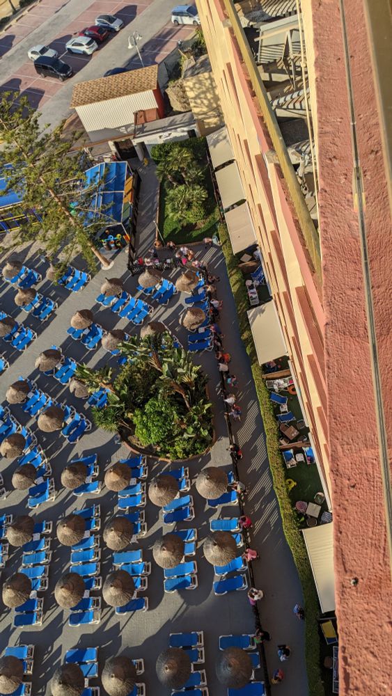 A long queue by the pool gate 