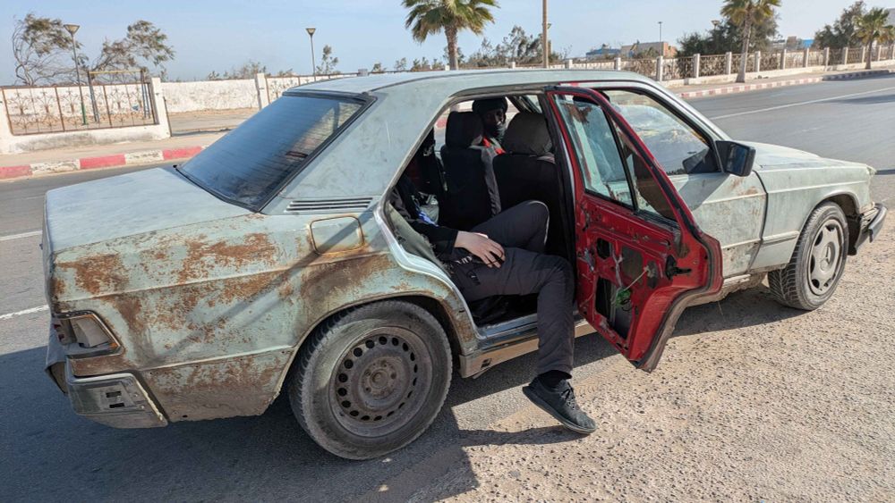 Me getting out of a very worn-out taxi