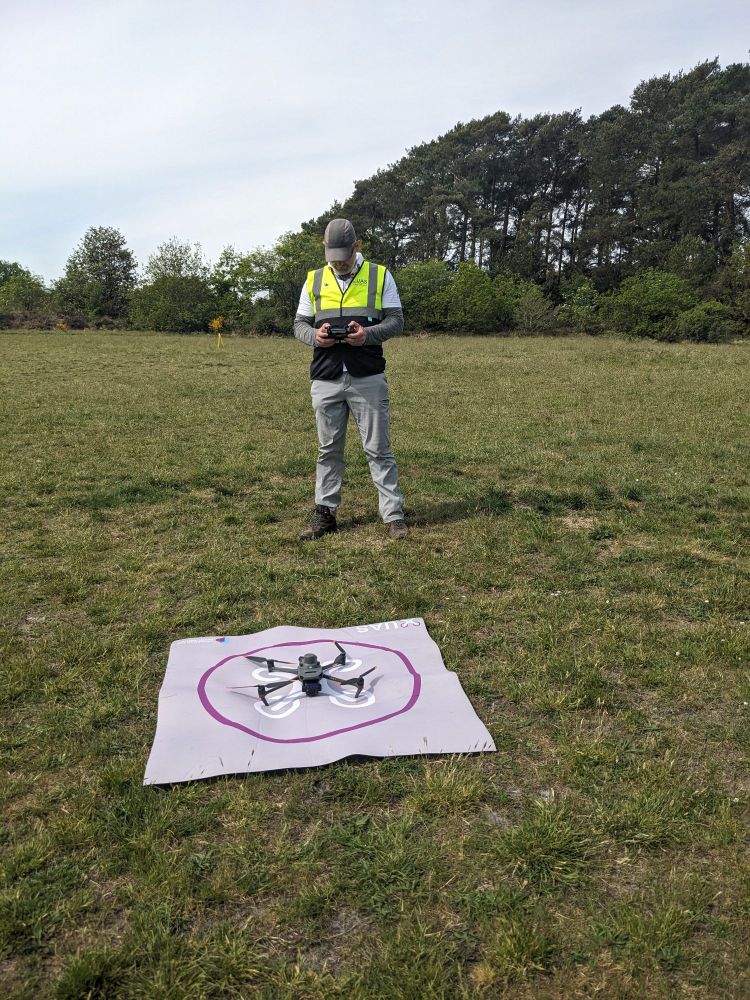 A person piloting a grounded drone