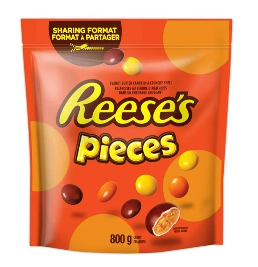 Large orange paper package of Reese’s Pieces candies