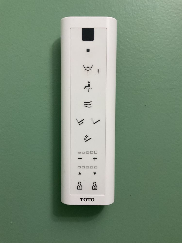 Remote control for a Toto brand bidet with multiple buttons to control the blessed rain shooting at your bum
