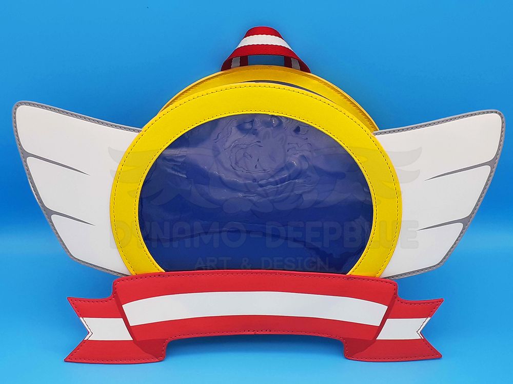A photograph of an ita bag shaped like the emblems on title screens of various Sonic the Hedgehog games.