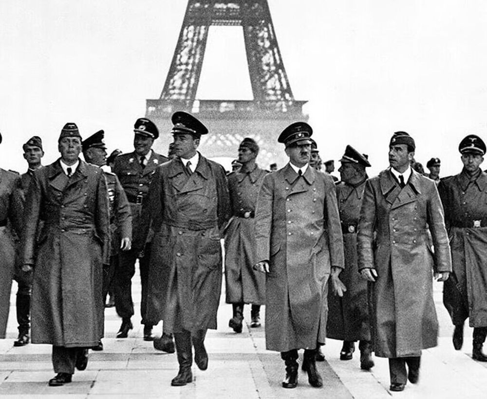 Hitler and his entourage strutting in front of the Eiffel Tower