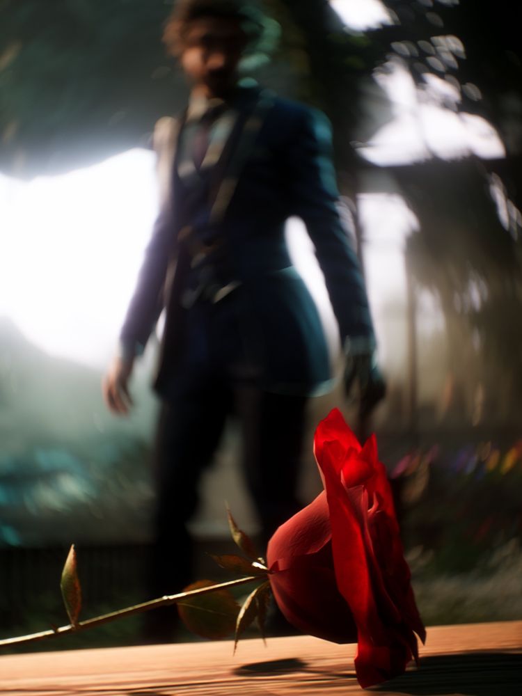 Gustave stands in front of red rose, swirly bokeh